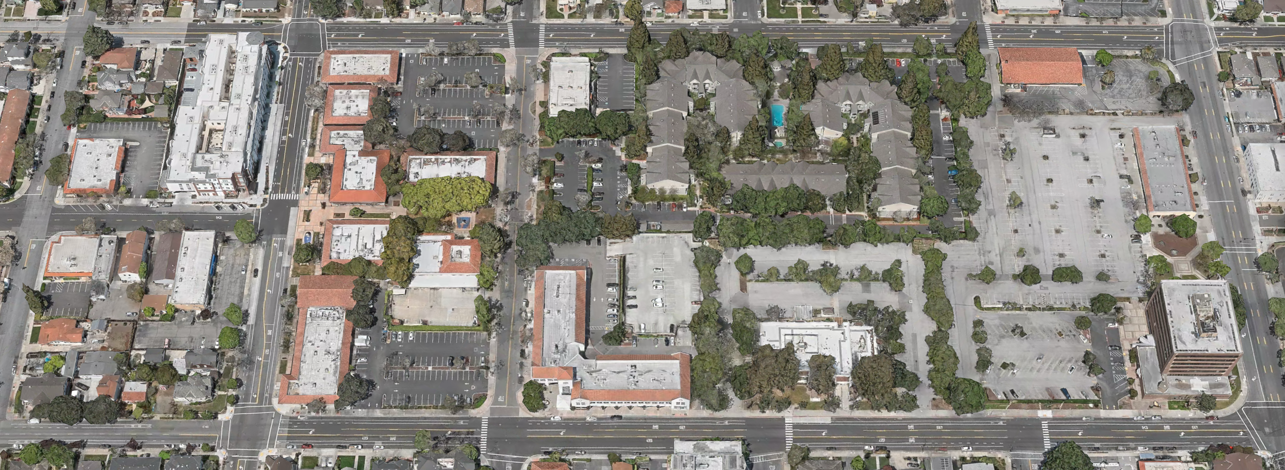 Aerial view of the old downtown area today: Franklin Street interrupted by city-owned parking lots and a sprawling apartment complex.